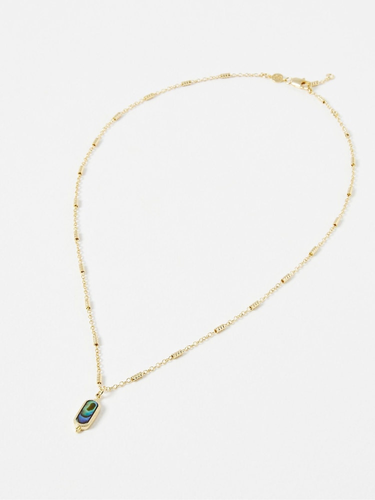Oliver Bonas Grey Alys Oval Paua Shell Gold Tone Plated Pendant Necklace - Image 1 of 5 Oliver Bonas Grey Alys Oval Paua Shell Gold Tone Plated Pendant Necklace - Image 1 of 5