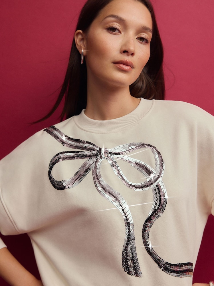 Ecru/Silver Christmas Sparkle Sequin Front Bow Graphic Crew Neck Sweatshirt - Image 1 of 8