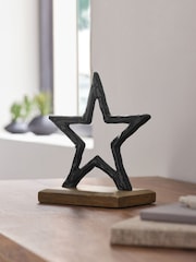 Black Metal Star Ornament on Dark Bronx Wooden Base - Image 1 of 5