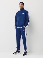 أزرق - بدلة رياضة أساسية منسوجة مُزيّنة بـ 3 خطوط من adidas Sportswear - صورة 1 من 7