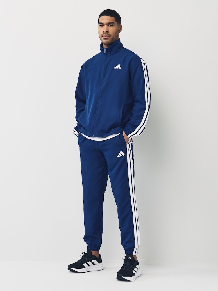 أزرق - بدلة رياضة أساسية منسوجة مُزيّنة بـ 3 خطوط من adidas Sportswear - صورة 1 من 7