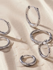 Silver Tone Stainless Steel Graduated Huggie Hoop Earrings 3 Pack - Image 6 of 6
