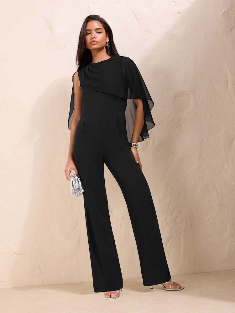 Friends Like These Black Asymmetric Cape Sleeve Jumpsuit - Image 1 of 6