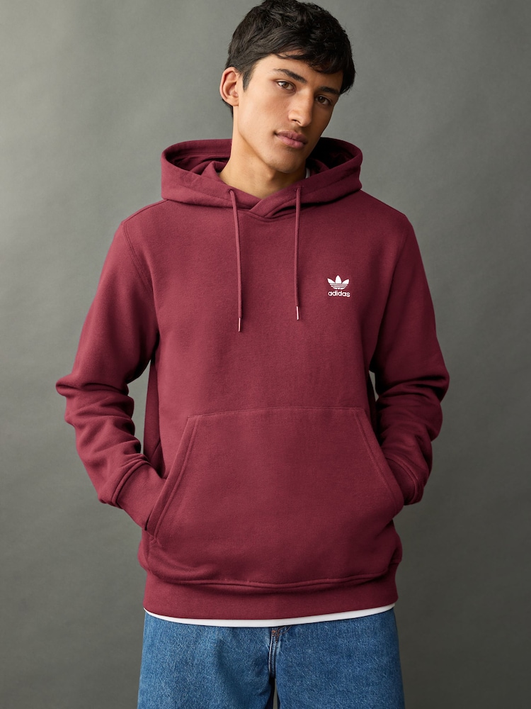 أحمر - سترة هودي Trefoil Essentials من Adidas Originals - صورة 1 من 7 أحمر - سترة هودي Trefoil Essentials من Adidas Originals - صورة 1 من 7