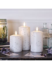Lights4fun White Truglow LED Pillar Candles with Moon Star Design Set of 3 - Image 1 of 2