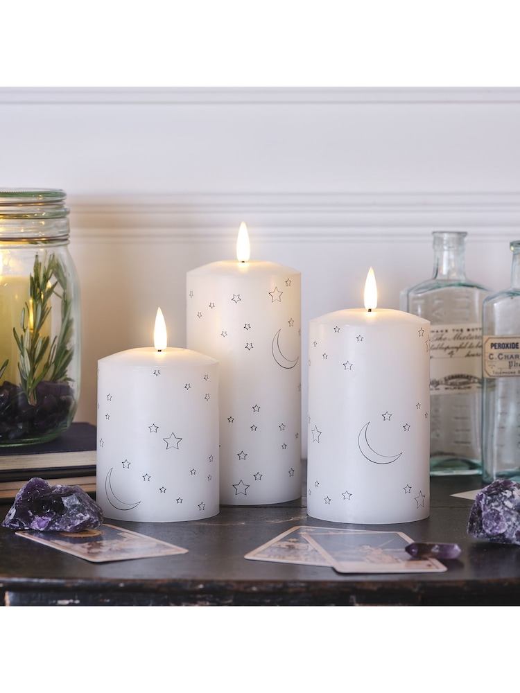 Lights4fun White Truglow LED Pillar Candles with Moon Star Design Set of 3 - Image 1 of 2