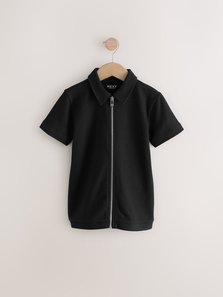 Negro - Zip Through Short Sleeve 100% Cotton Polo Shirt (3-16yrs) - Imagen 1 de 4 Negro - Zip Through Short Sleeve 100% Cotton Polo Shirt (3-16yrs) - Imagen 1 de 4