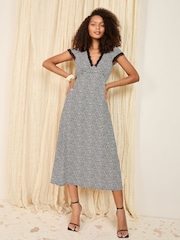 Friends Like These Black and White Spot Textured V-Neck Lace Trim Midi Dress - Image 1 of 4