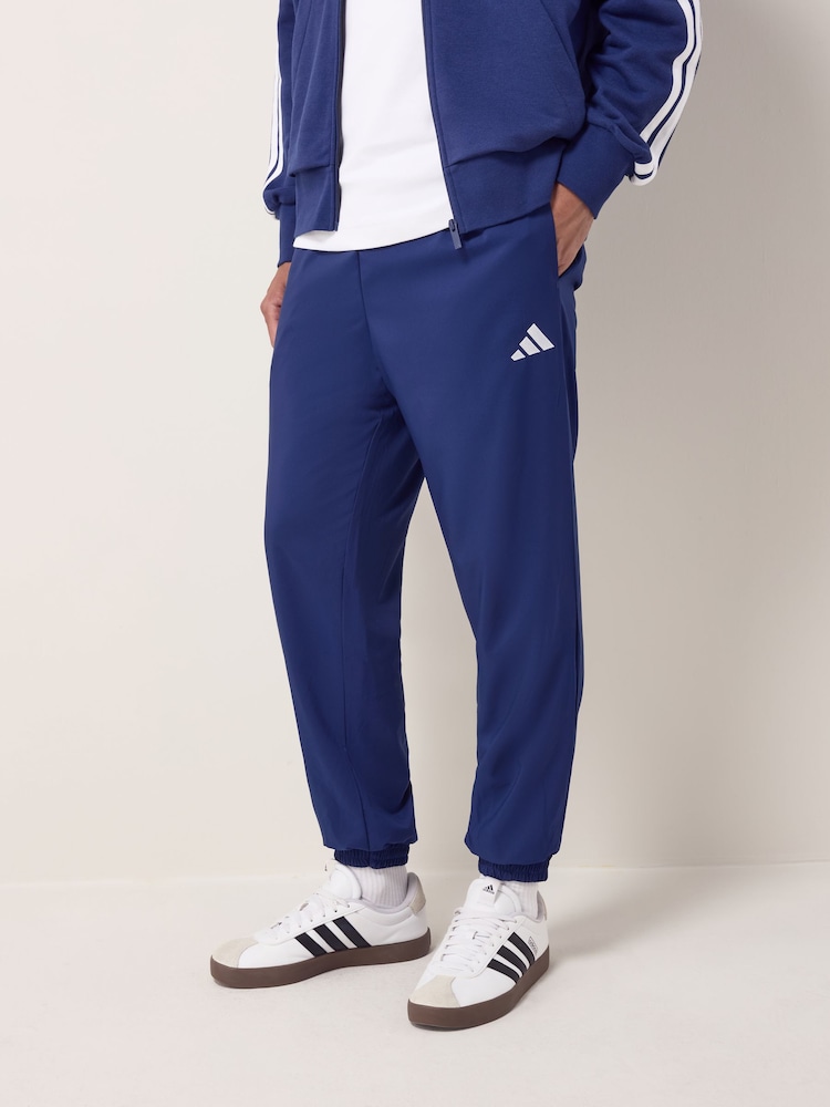 adidas Blue Essentials Small Logo Stanford Joggers - Image 1 of 6 adidas Blue Essentials Small Logo Stanford Joggers - Image 1 of 6