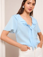 Friends Like These Blue Petite Short Sleeve Ruffle Bow Front Blouse - Image 1 of 5
