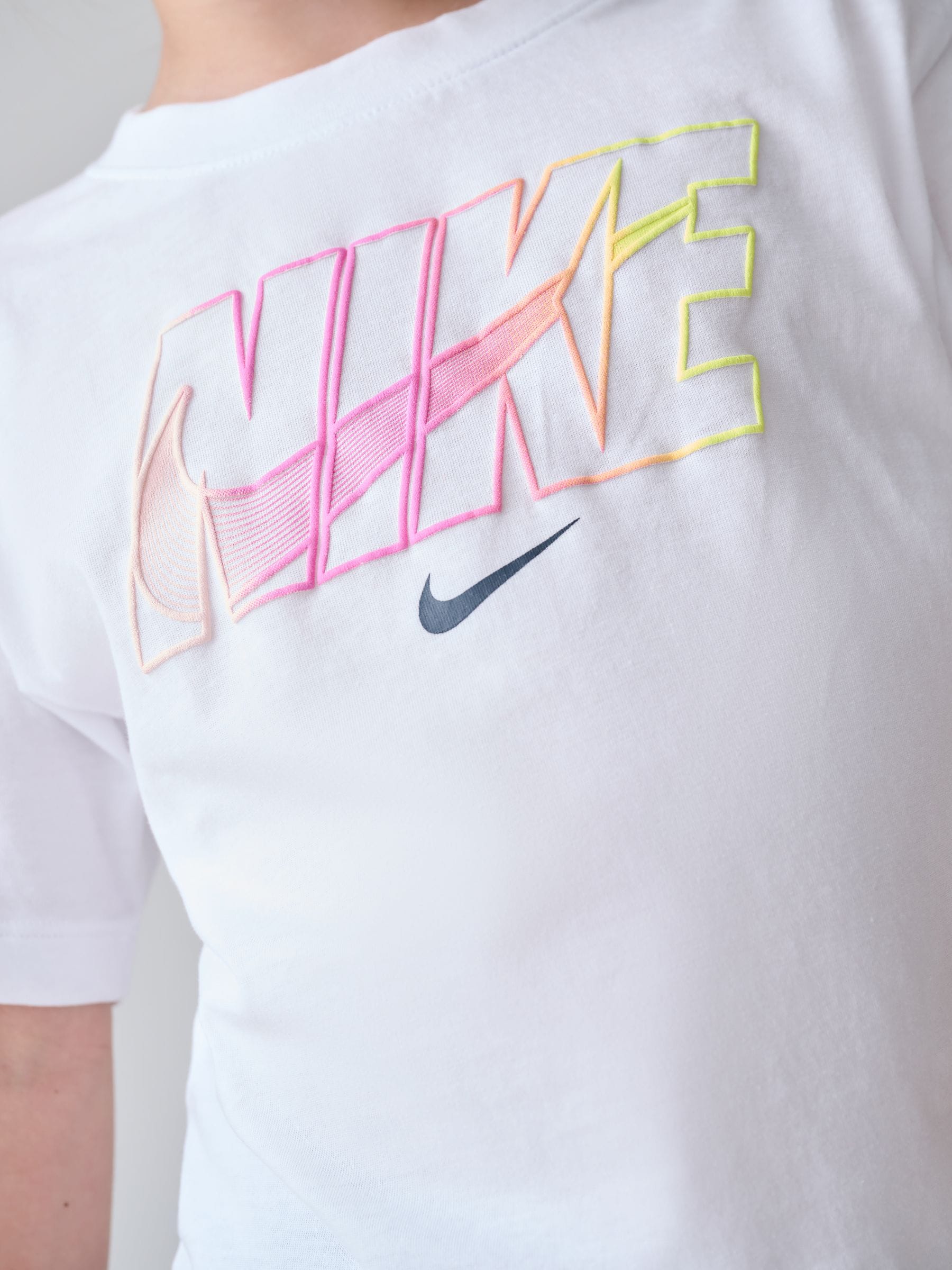 white nike shirt with pink logo