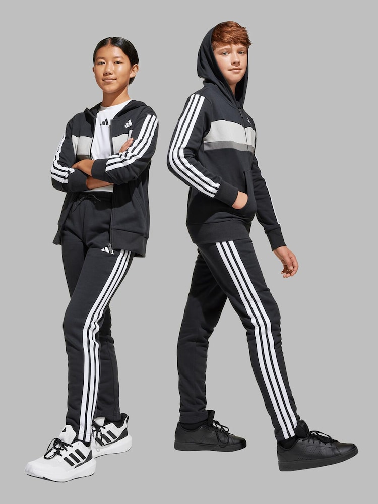 adidas Black/White Seasonal Essentials Tiberio 3-Stripes Fleece Kids Tracksuit - Image 1 of 8 adidas Black/White Seasonal Essentials Tiberio 3-Stripes Fleece Kids Tracksuit - Image 1 of 8