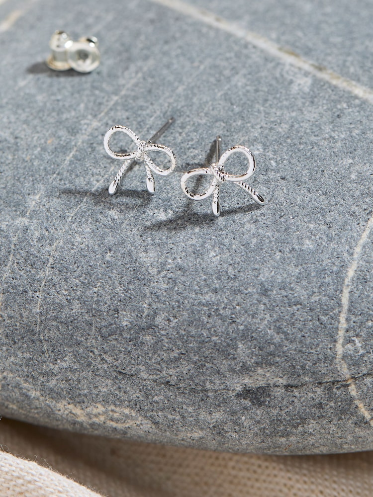 FatFace Silver Tone Bow Stud Earrings - Image 2 of 2 FatFace Silver Tone Bow Stud Earrings - Image 2 of 2