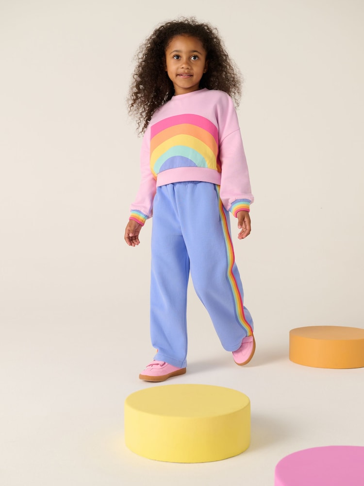 Little Bird by Jools Oliver Pink/Lilac Pastel Rainbow Sweatshirt and Wide Leg Joggers Set - Image 1 of 6 Little Bird by Jools Oliver Pink/Lilac Pastel Rainbow Sweatshirt and Wide Leg Joggers Set - Image 1 of 6