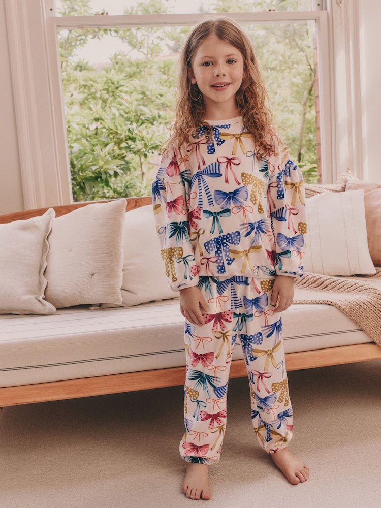 Multi Bow Print Cosy Fleece Pyjamas (9mths-16yrs) - Image 1 of 8 Multi Bow Print Cosy Fleece Pyjamas (9mths-16yrs) - Image 1 of 8