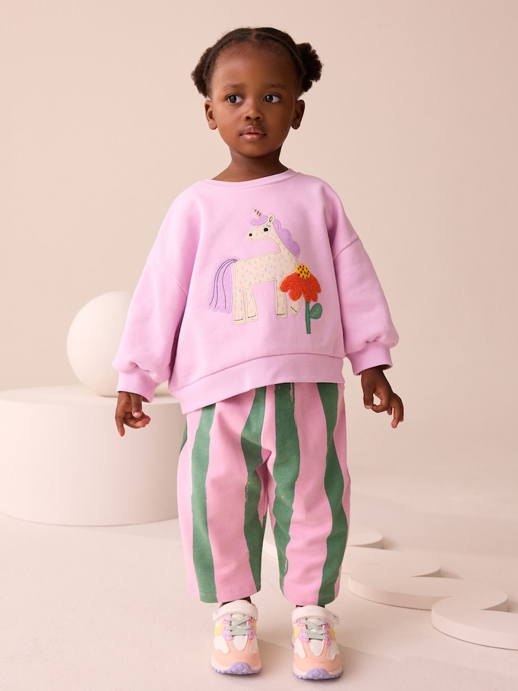 Pink Stripe Unicorn - طقم من بنطلون ضيق برِجل واسعة وسويت شيرت (3 شهر - 7 سنوات) - صورة 1 من 10 Pink Stripe Unicorn - طقم من بنطلون ضيق برِجل واسعة وسويت شيرت (3 شهر - 7 سنوات) - صورة 1 من 10