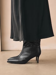 Black Forever Comfort® Point Toe Heel Slouch Knee High Boots - Image 3 of 12