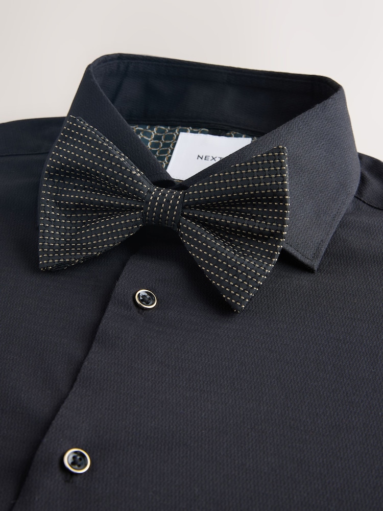 black dress shirt with blue bow tie Handsome Black ,man in blue shirt and bow tie looking thoughtful Stock Photo