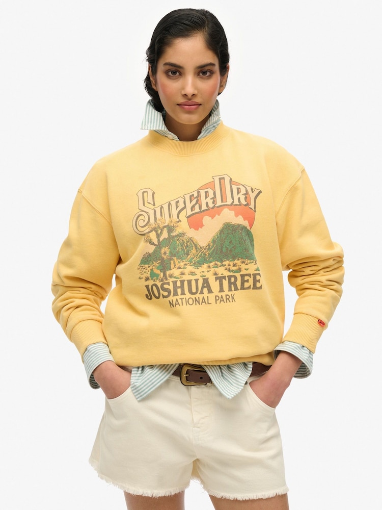 Superdry Yellow Souvenir Graphic Print Loose Crew 100% Cotton Sweatshirt - Image 1 of 6 Superdry Yellow Souvenir Graphic Print Loose Crew 100% Cotton Sweatshirt - Image 1 of 6