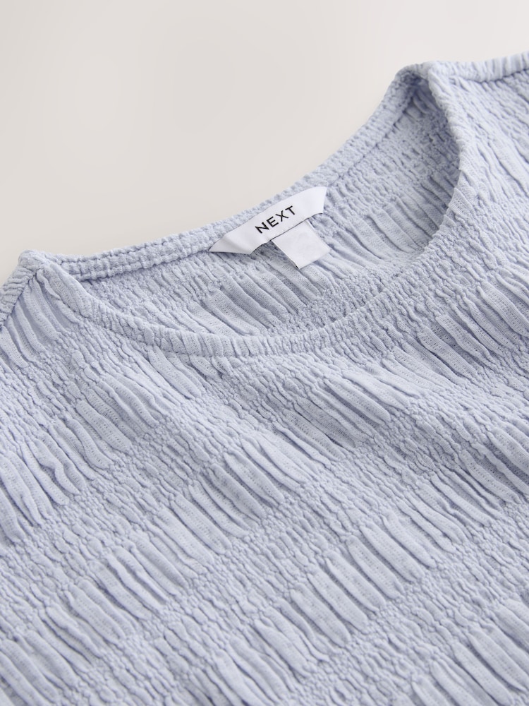 DESIGN - Cardigan a maniche corte girocollo ruggine con peplo a