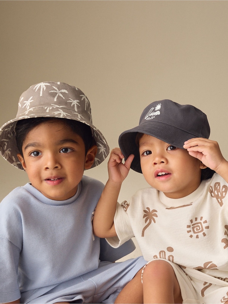 Black/Tan Palm Tree Bucket Hats 2 Pack (3mths-13yrs) - Image 1 of 8 Black/Tan Palm Tree Bucket Hats 2 Pack (3mths-13yrs) - Image 1 of 8