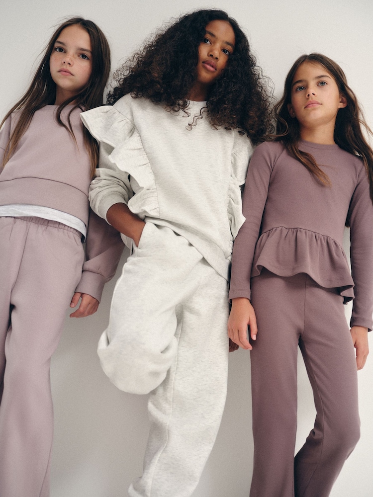 The Set 6 Piece Frill Crew Neck Long Sleeve Peplum Rib Flare Balloon Leg and Wide Leg T-Shirt and Joggers Set Purple/Lilac/Grey Marl - Image 1 of 18
