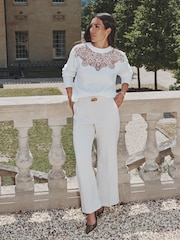 Lipsy x Gemma Owen Ecru Petite Relaxed Flare Tailored Trousers with Belt - Image 1 of 5