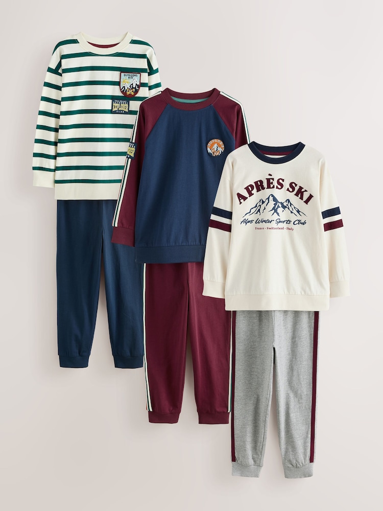 Navy/Ecru Apres Ski Graphic Long Sleeve Jogger Pyjamas Set 3 Pack (3-16yrs) - Image 1 of 7 Navy/Ecru Apres Ski Graphic Long Sleeve Jogger Pyjamas Set 3 Pack (3-16yrs) - Image 1 of 7