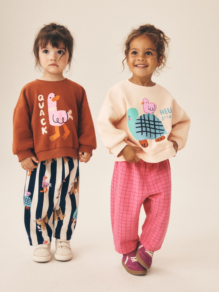 Pink/Ecru Duck Character Sweatshirt and Barrel Trousers Set 2 Pack (3mths-7yrs) - Image 1 of 5 Pink/Ecru Duck Character Sweatshirt and Barrel Trousers Set 2 Pack (3mths-7yrs) - Image 1 of 5