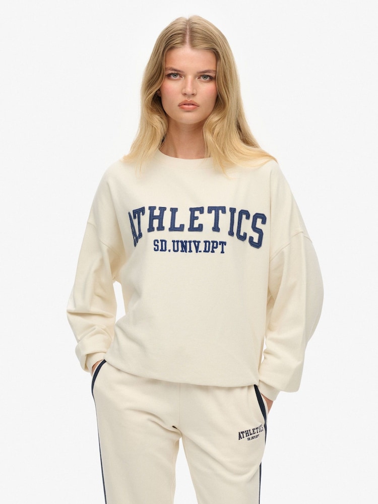 Superdry White Athletic Essentials Appliqué Crew Neck Sweatshirt - Image 1 of 7 Superdry White Athletic Essentials Appliqué Crew Neck Sweatshirt - Image 1 of 7
