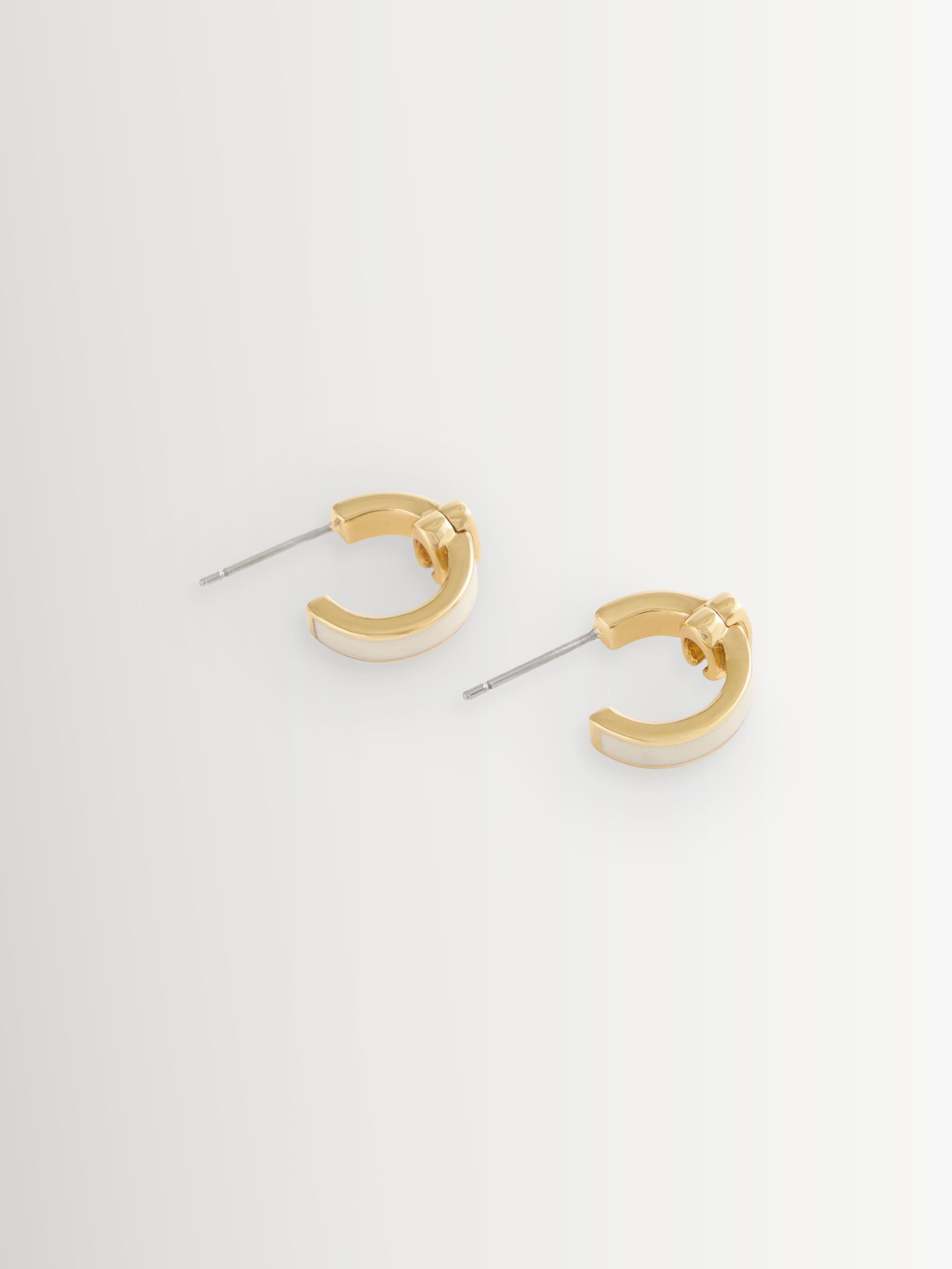 Buy COACH Cream Signature C Enamel Huggie Earrings from the Next UK ...