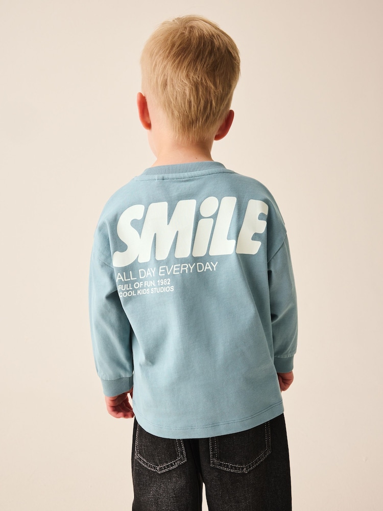 Mineral Blue Smile All Day Everyday Long Sleeve Back Graphic T-Shirt (3mths-7yrs) - Image 1 of 8 Mineral Blue Smile All Day Everyday Long Sleeve Back Graphic T-Shirt (3mths-7yrs) - Image 1 of 8