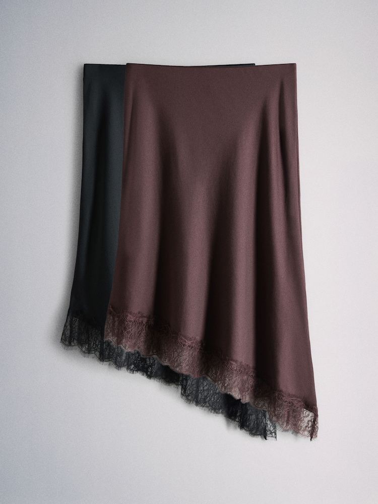 The Set 2 Pack Satin Crepe Lace Hem Asymmetric Midi Skirts Black/Plum - Image 1 of 6 The Set 2 Pack Satin Crepe Lace Hem Asymmetric Midi Skirts Black/Plum - Image 1 of 6
