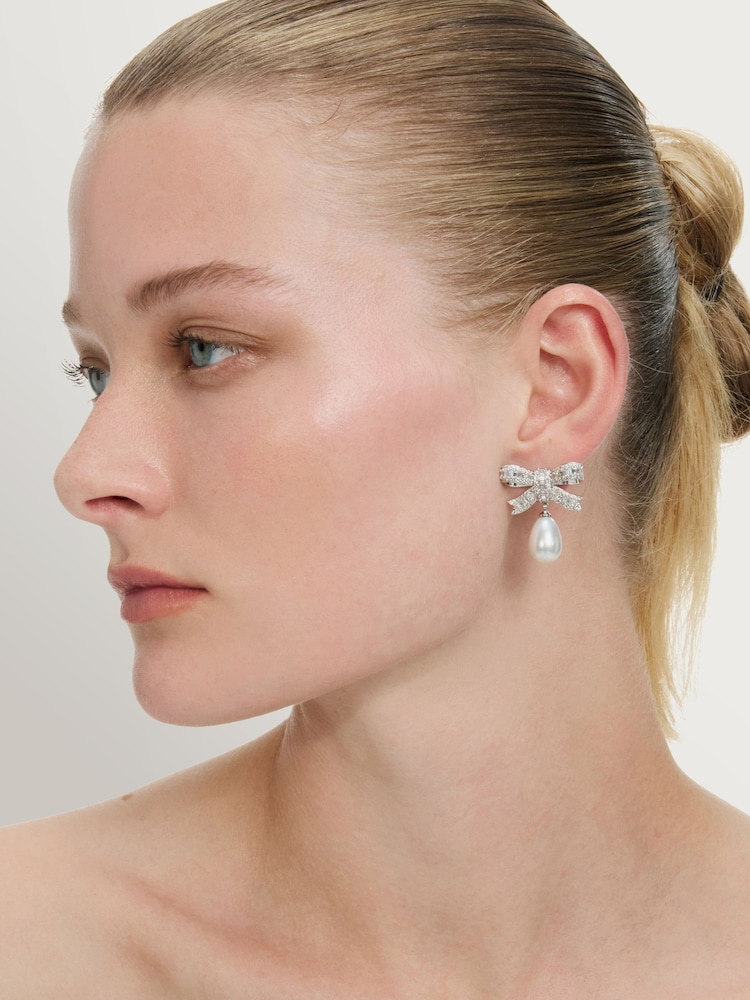 Self-Portrait Silver Tone Crystal Bow Pearl Droplet Earrings - Image 1 of 3 Self-Portrait Silver Tone Crystal Bow Pearl Droplet Earrings - Image 1 of 3