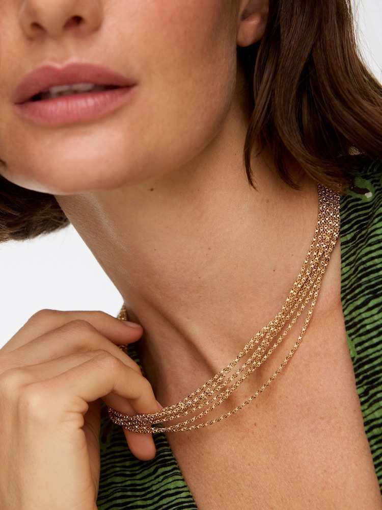 Oliver Bonas Gold Tone Jillian Multi Chain Statement Bow Layered Necklace - Image 1 of 4 Oliver Bonas Gold Tone Jillian Multi Chain Statement Bow Layered Necklace - Image 1 of 4