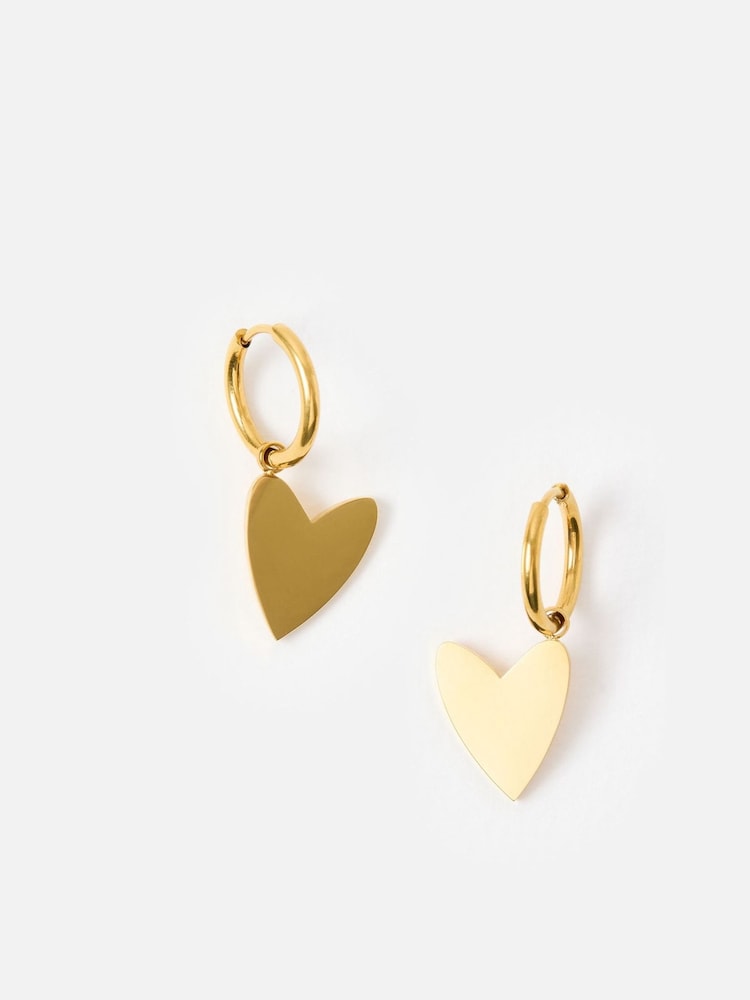 Oliver Bonas Gold Tone Billie Stainless Steel Waterproof Heart Huggie Earrings - Image 1 of 6 Oliver Bonas Gold Tone Billie Stainless Steel Waterproof Heart Huggie Earrings - Image 1 of 6