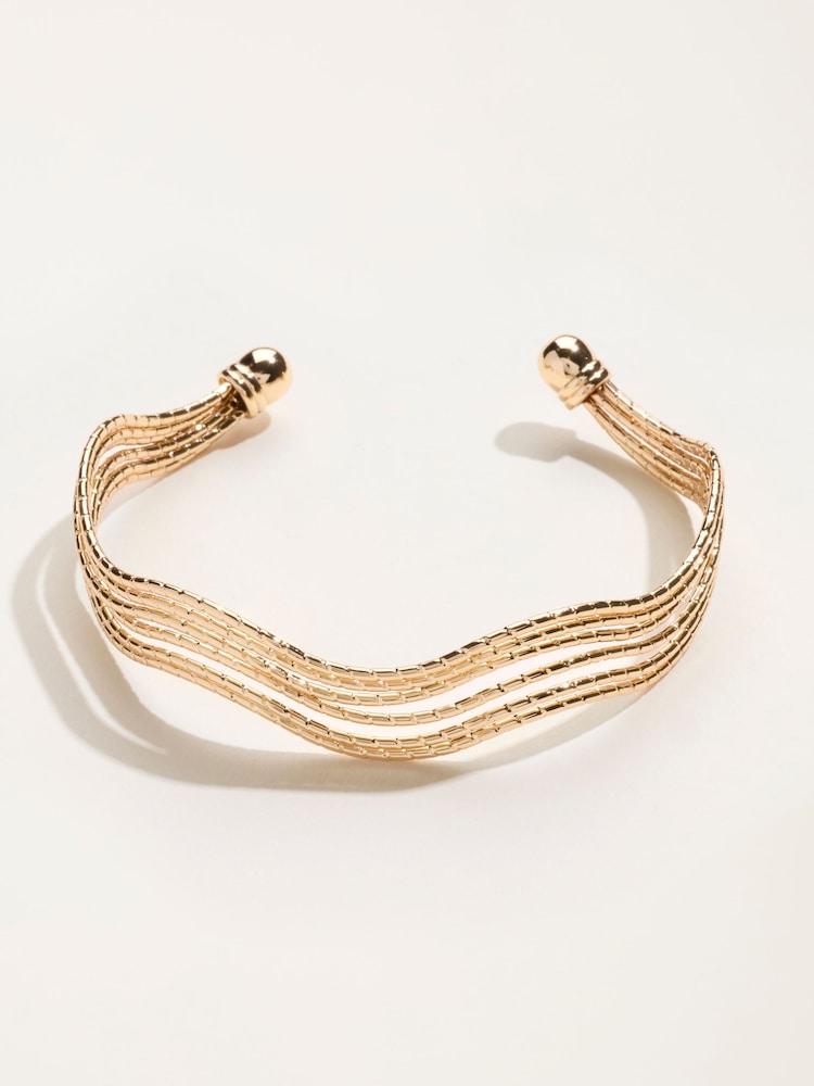 FatFace Gold Tone Wavy Bangle - Image 1 of 3 FatFace Gold Tone Wavy Bangle - Image 1 of 3