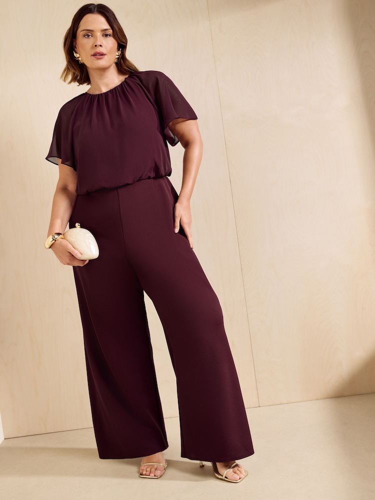 Friends Like These Aubergine Purple Curve Chiffon Flutter Sleeve Jumpsuit - Image 1 of 5 Friends Like These Aubergine Purple Curve Chiffon Flutter Sleeve Jumpsuit - Image 1 of 5