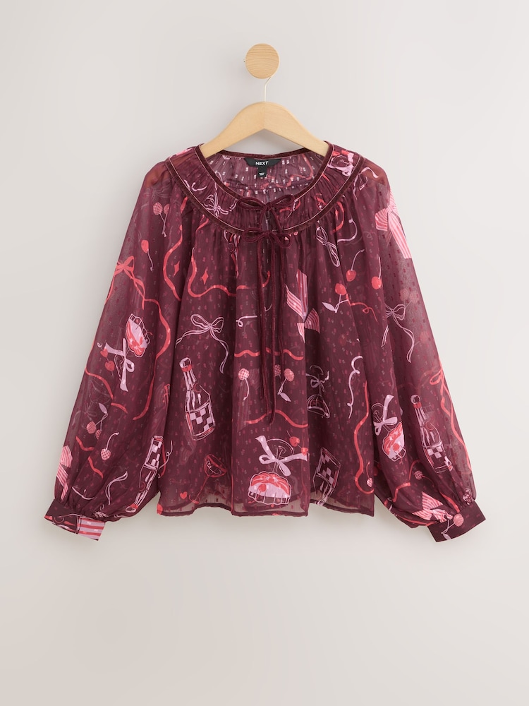 Burgundy Red/Pink Festive Bow Print Tie-Neck Long Sleeve Blouse - Image 1 of 3 Burgundy Red/Pink Festive Bow Print Tie-Neck Long Sleeve Blouse - Image 1 of 3