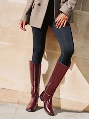 Lipsy Burgundy Red Glossy Patent Knee High Low Block Heel Riding Boots with Gold Stirrup Chain Detail - Image 3 of 6