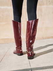 Lipsy Burgundy Red Glossy Patent Knee High Low Block Heel Riding Boots with Gold Stirrup Chain Detail - Image 5 of 6