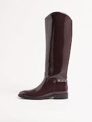 Lipsy Burgundy Red Glossy Patent Knee High Low Block Heel Riding Boots with Gold Stirrup Chain Detail - Image 6 of 6