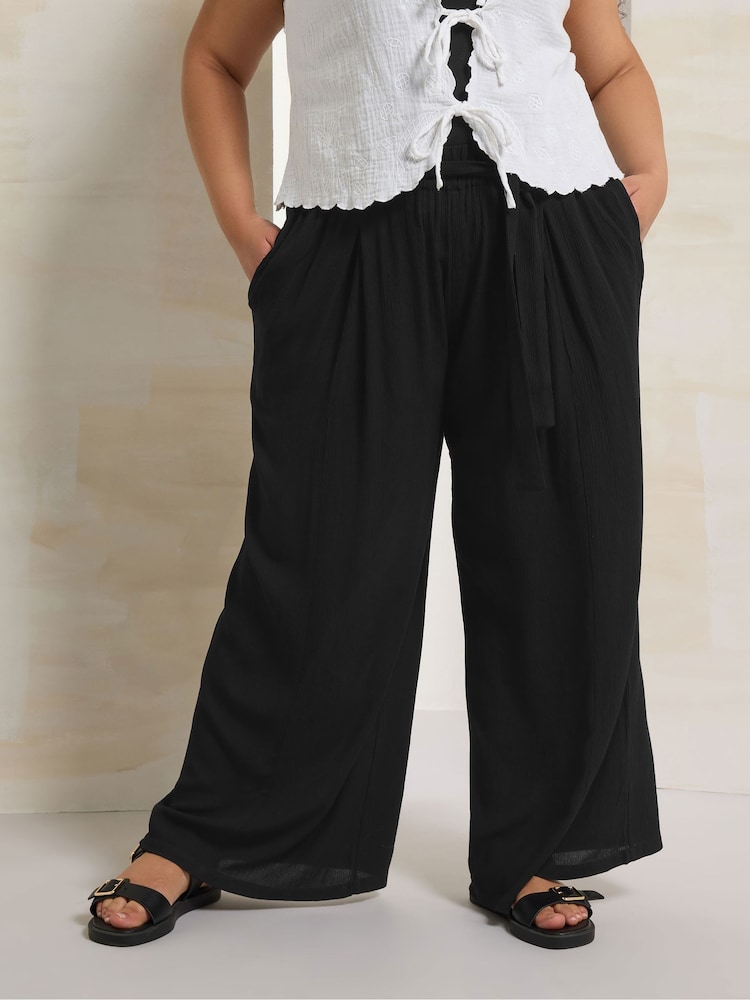 Yours Curve Black Crinkle Tie Waist Wide Leg Trousers - Image 1 of 5 Yours Curve Black Crinkle Tie Waist Wide Leg Trousers - Image 1 of 5