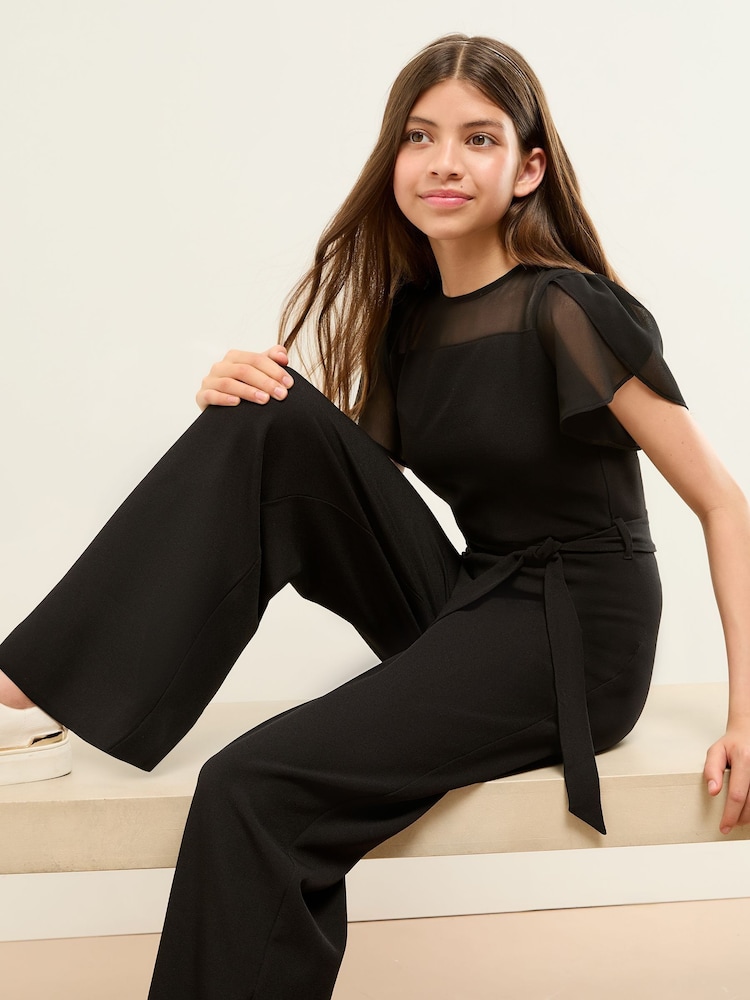 Lipsy Black Mesh Yoke Jumpsuit (5-16yrs) - Image 1 of 4 Lipsy Black Mesh Yoke Jumpsuit (5-16yrs) - Image 1 of 4
