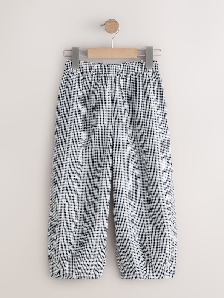 أسود/أبيض مربعات - بنطلون واسع بتصميم سهل الارتداء (3-16 سنة) - Image 1 of 4
