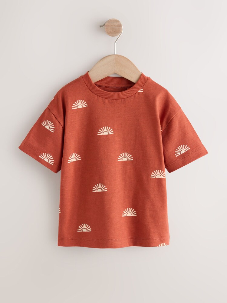 Rust Red Sun Short Sleeve All Over Print T-Shirt (3mths-7yrs) (3mths-7yrs) - Image 1 of 4 Rust Red Sun Short Sleeve All Over Print T-Shirt (3mths-7yrs) (3mths-7yrs) - Image 1 of 4
