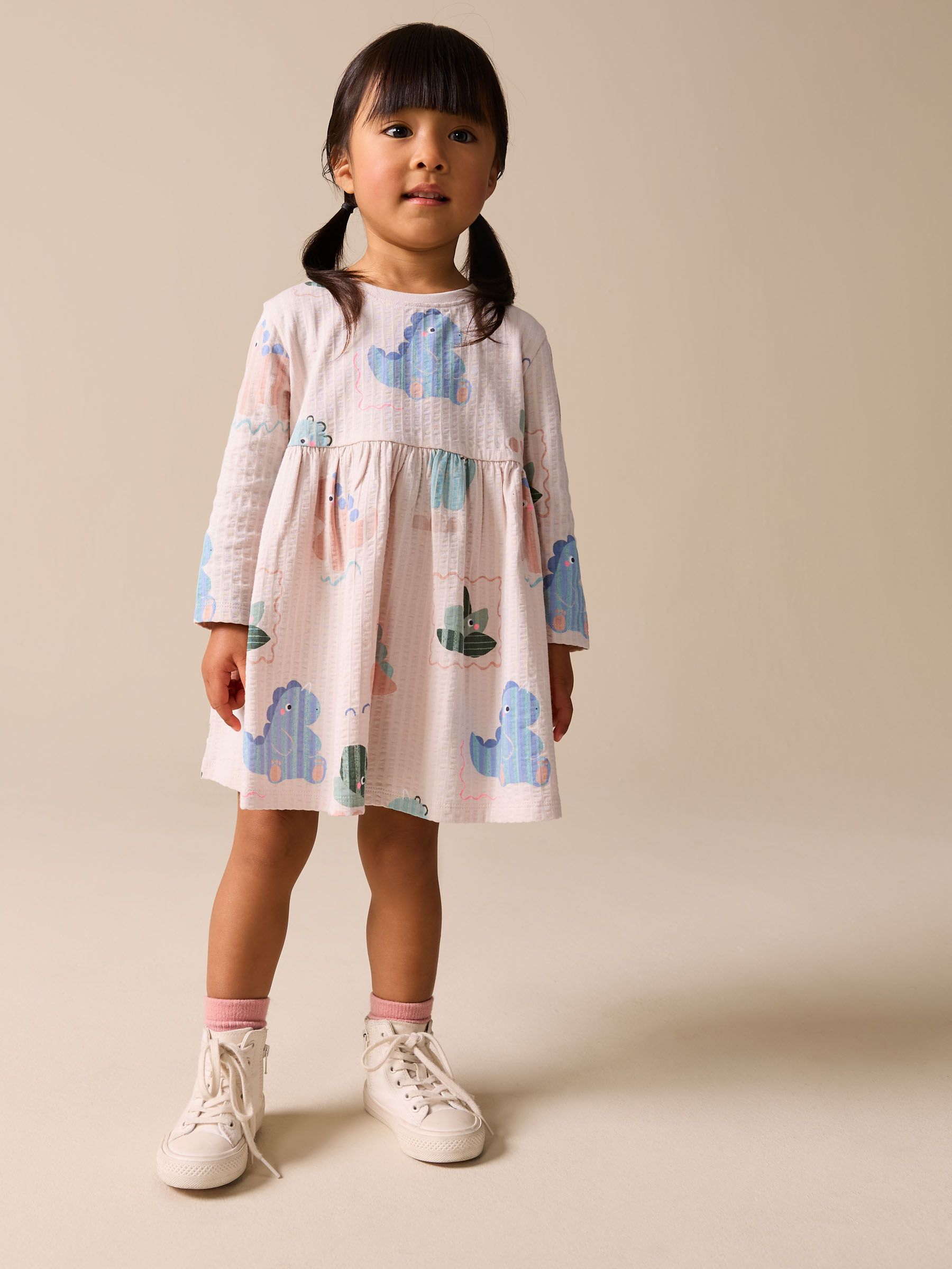 Buy Cream Dinosaur Long Sleeve Jersey Dress (3mths-7yrs) from the