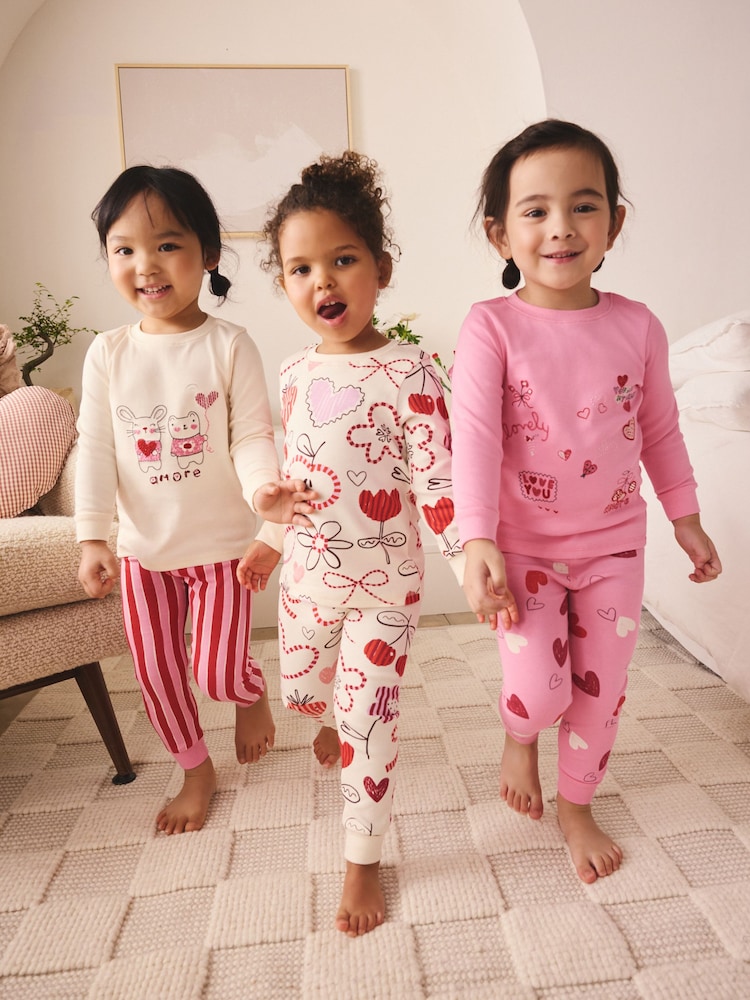 Pink/Red Galentines Snuggle Pyjamas 3 Pack (9mths-12yrs) - Image 1 of 4 Pink/Red Galentines Snuggle Pyjamas 3 Pack (9mths-12yrs) - Image 1 of 4