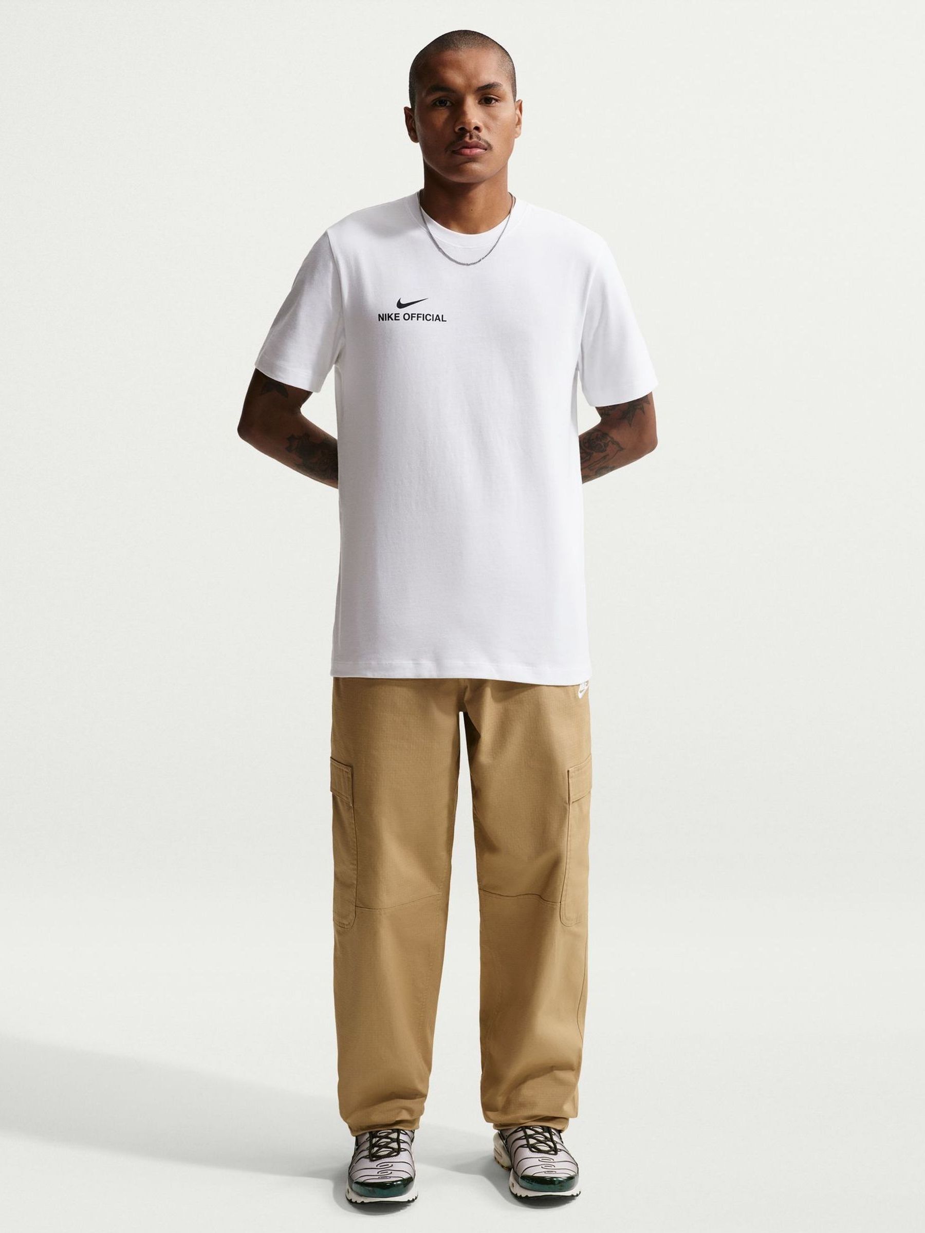 white and tan nike shirt