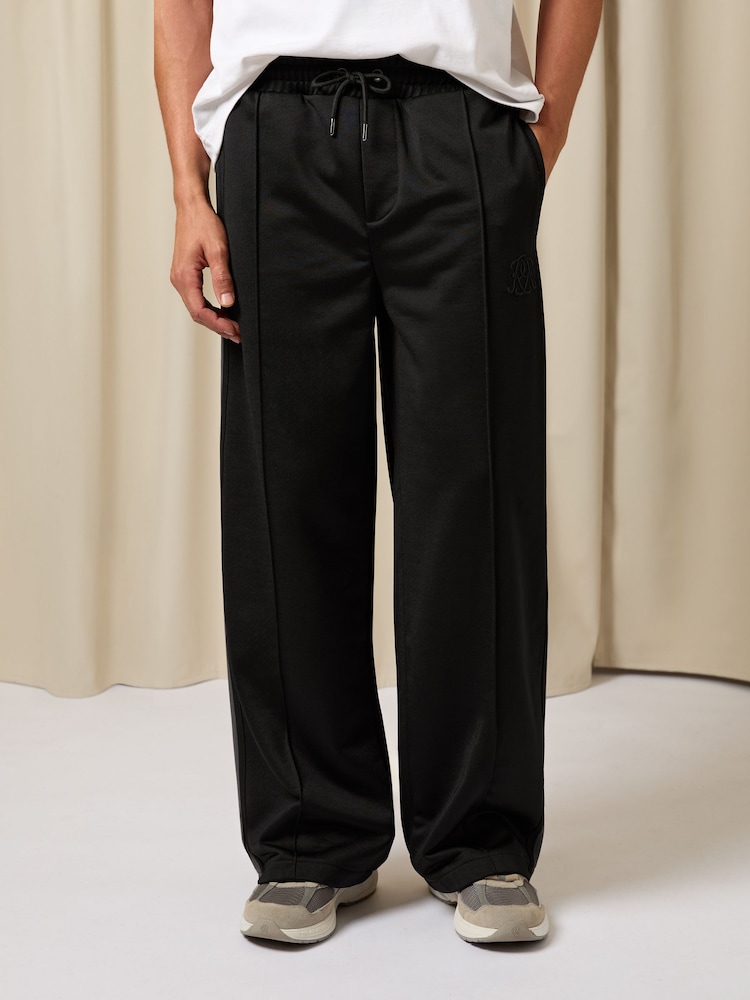 Reiss Black Foster Monogram Cotton Wide-Leg Joggers - Image 1 of 6 Reiss Black Foster Monogram Cotton Wide-Leg Joggers - Image 1 of 6